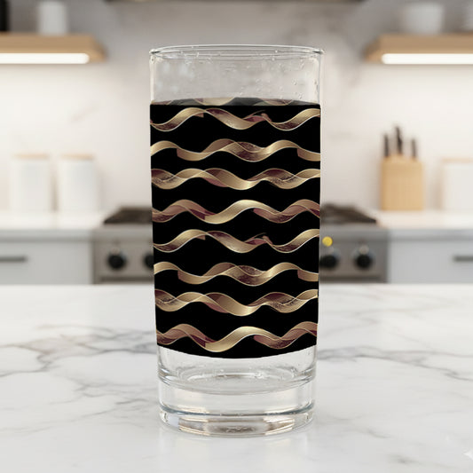 Liquid Gold highball glasses in a black and gold wavy design on a kitchen counter
