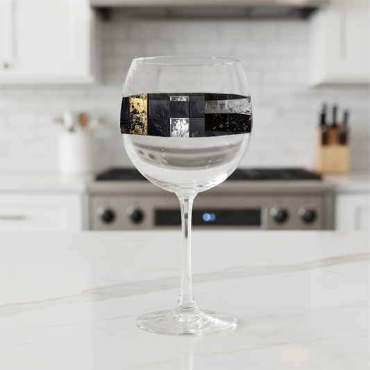 Freseco Fragments balloon wine glass with a band of aged patina fragments design on a kitchen counter