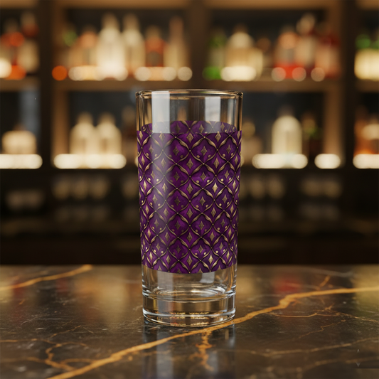 Royal Opulence hightball glass with plum and gold design on a dark marble surcase, blurred background.