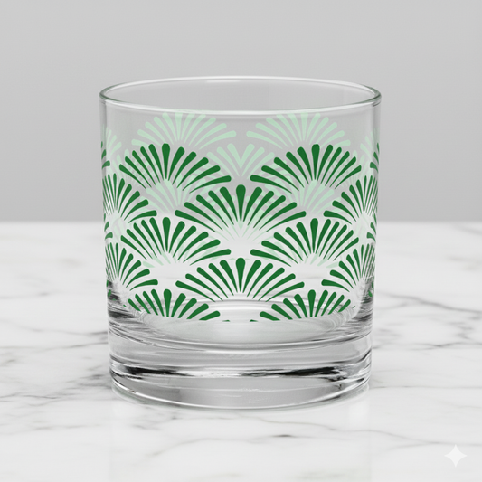Green Deco rocks glass with Art-Deco motif design on a marble surface