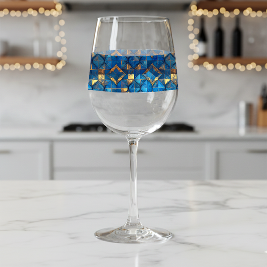 Moroccan Treasure tall wine glass with decorative blue and gold design on a marble counter