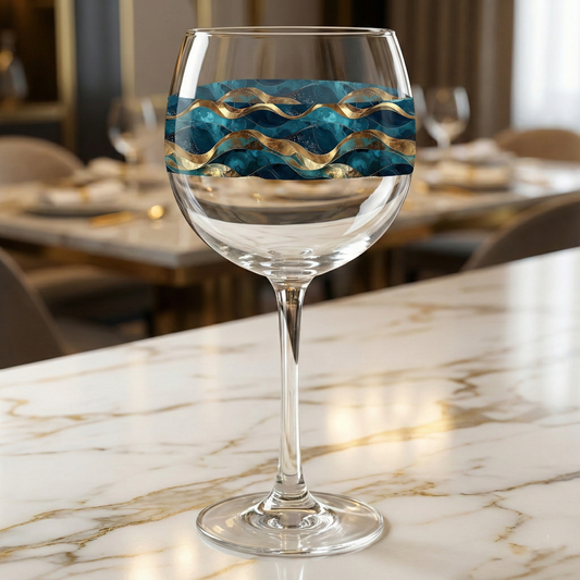Opulent Teal balloon wine glass closeup on a marble countertop, showcasing wide bowl and sophisticated teal and gold marbling design.