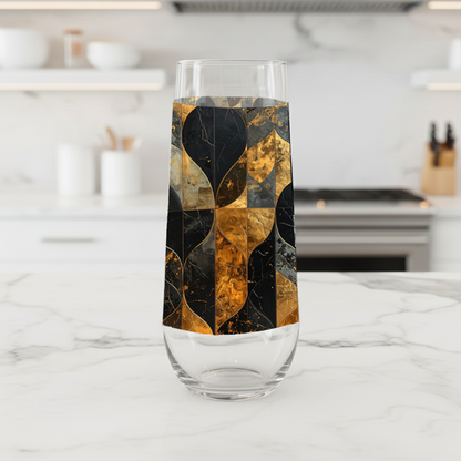 Aged Elegance stemless champagne glass with charcoal and bronze decorative pattern on a kitchen counter