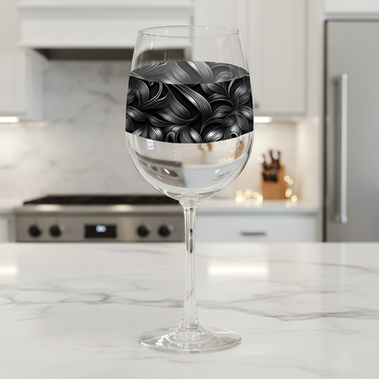 Baroque Swirls wine glass with silver and gray swirl design on a marble countertop