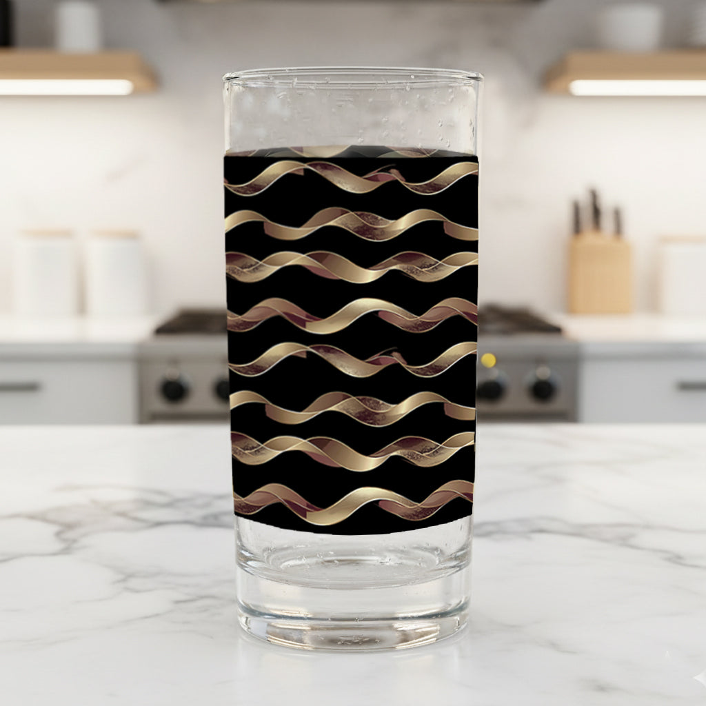 Liquid Gold highball glasses in a black and gold wavy design on a kitchen counter