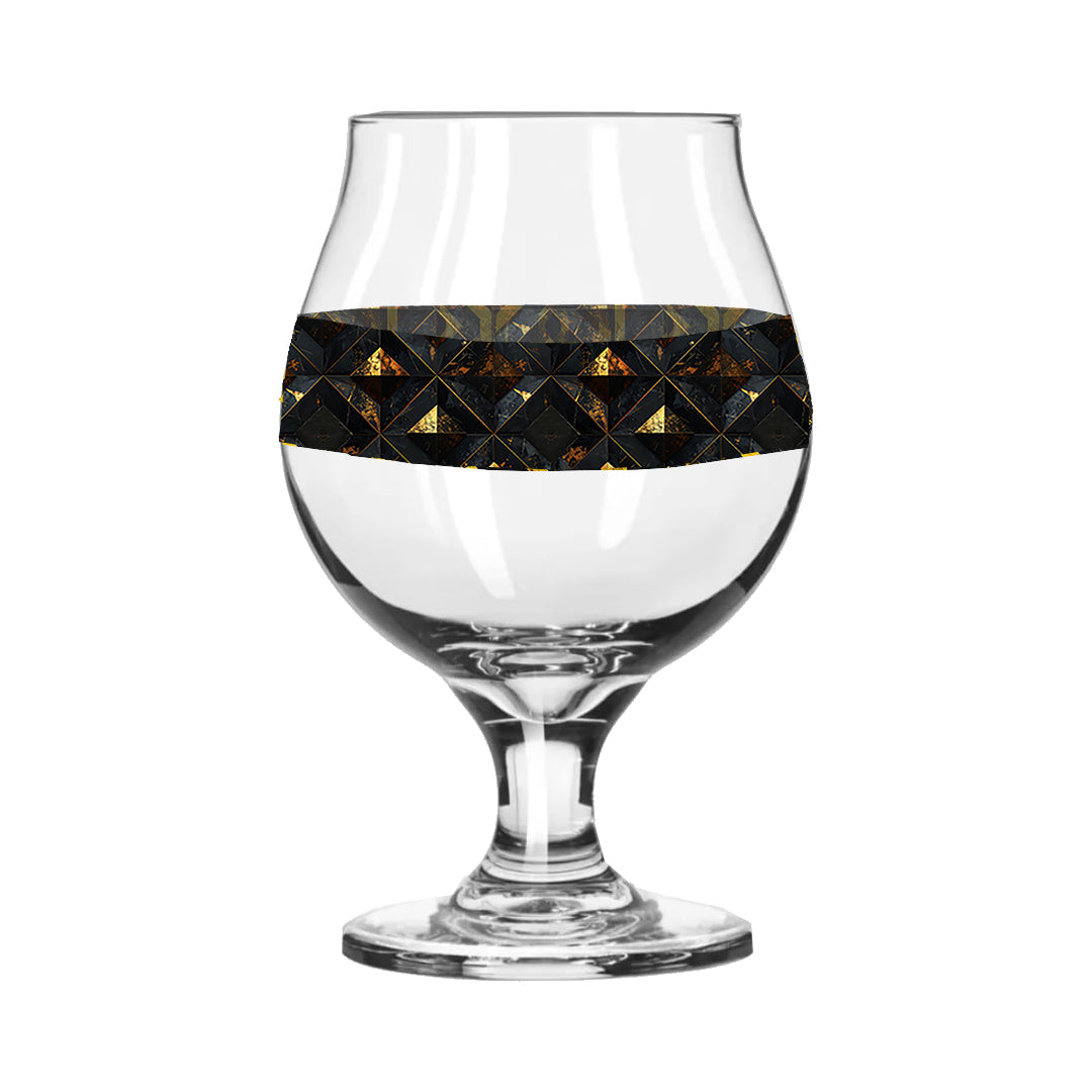Belgian beer glass with black and gold diamond design on a white background