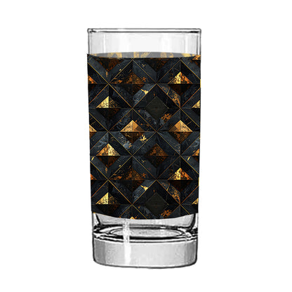 Highball glass with a geometric black and gold pattern on a white background