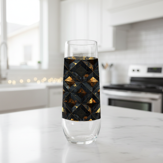 Gilded Decay stemless champagne glass with charcoal and gold geometric with black design on a kitchen counter