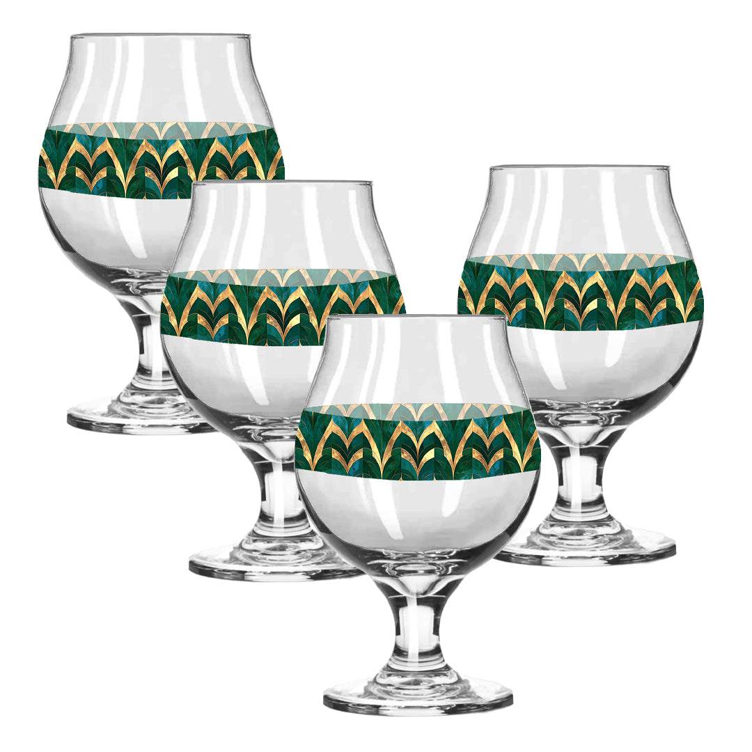 Set of four Belgian beer glasses with with green and gold geometric design on a white background