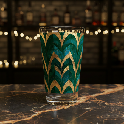 Emerald Royale pint beer glass with green and gold pattern on a marble surface with blurred bar background