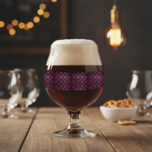 Royal Opulence Belgian glass of beer with a plum and gold decorative design on a wooden table with blurred lights in the background