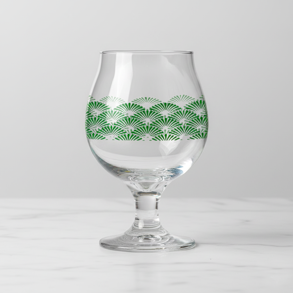 Green Deco Belgian beer glass with an Art-Deco design on a light gray background