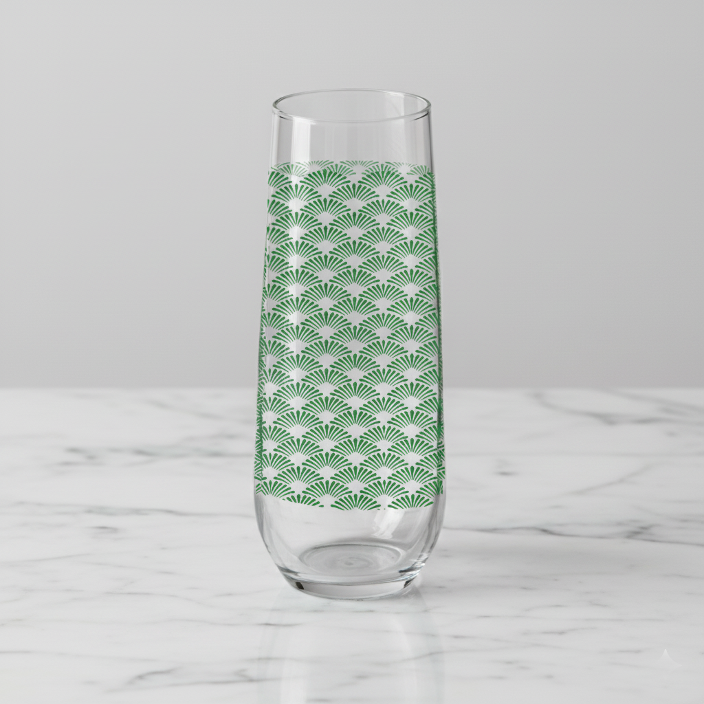 Green Deco stemleess champagne glass with Art Deco fan design on a white marble counter