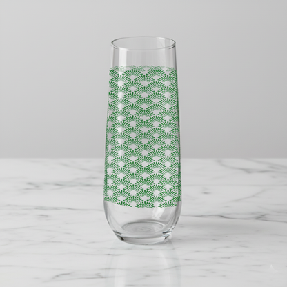 Green Deco stemleess champagne glass with Art Deco fan design on a white marble counter