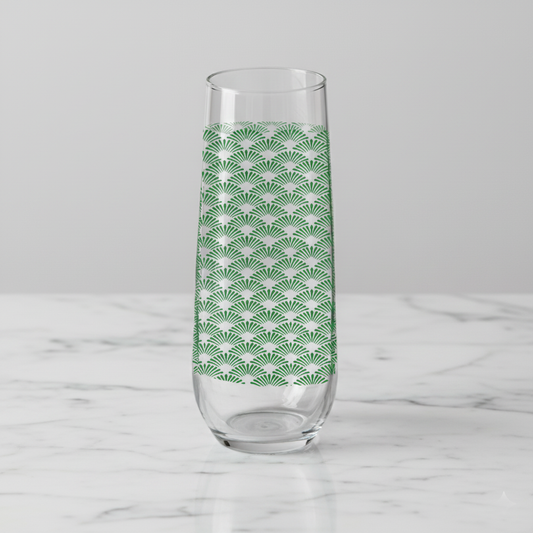 Green Deco stemleess champagne glass with Art Deco fan design on a white marble counter