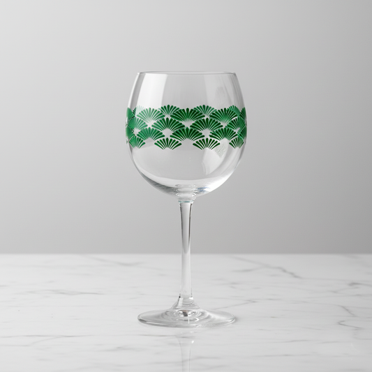 Green Deco balioon wine glass with green Art-Deco fan design on a light gray background