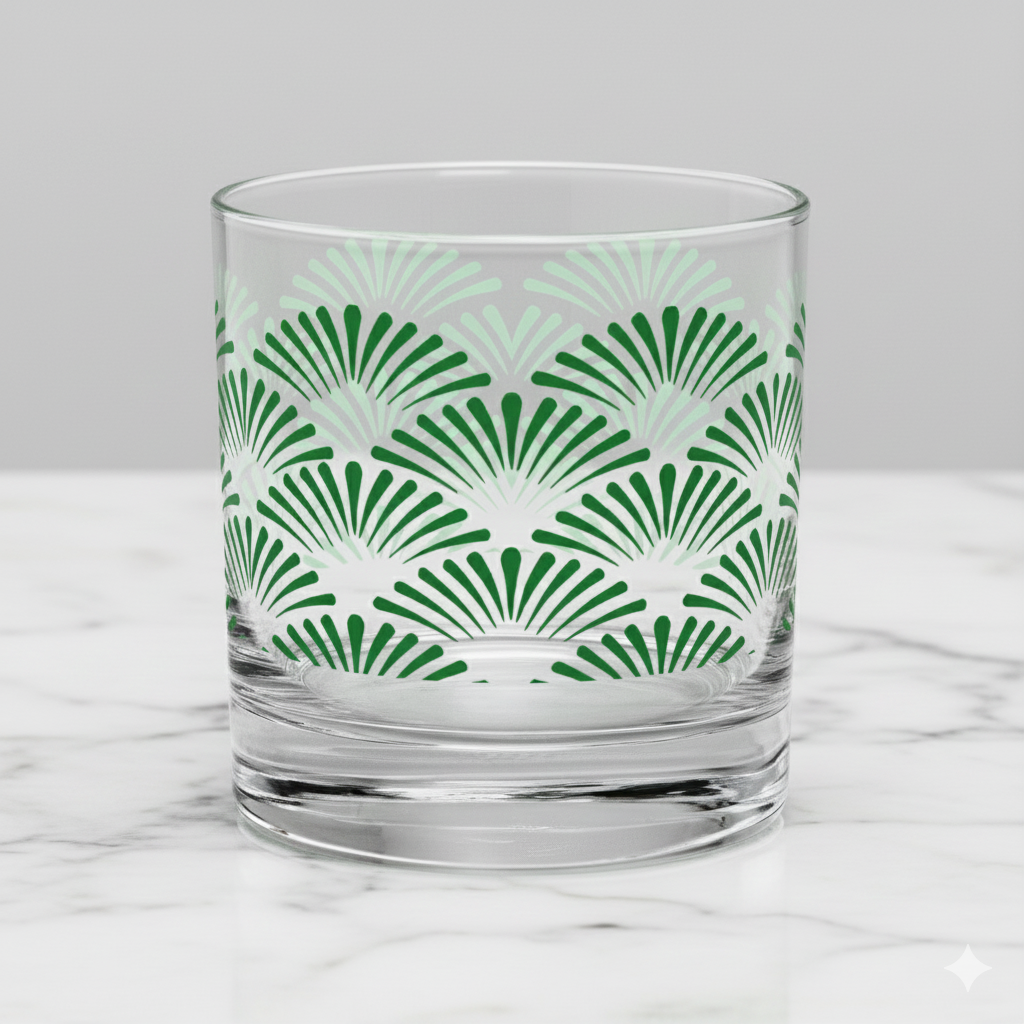 Green Deco rocks glass with Art-Deco motif design on a marble surface