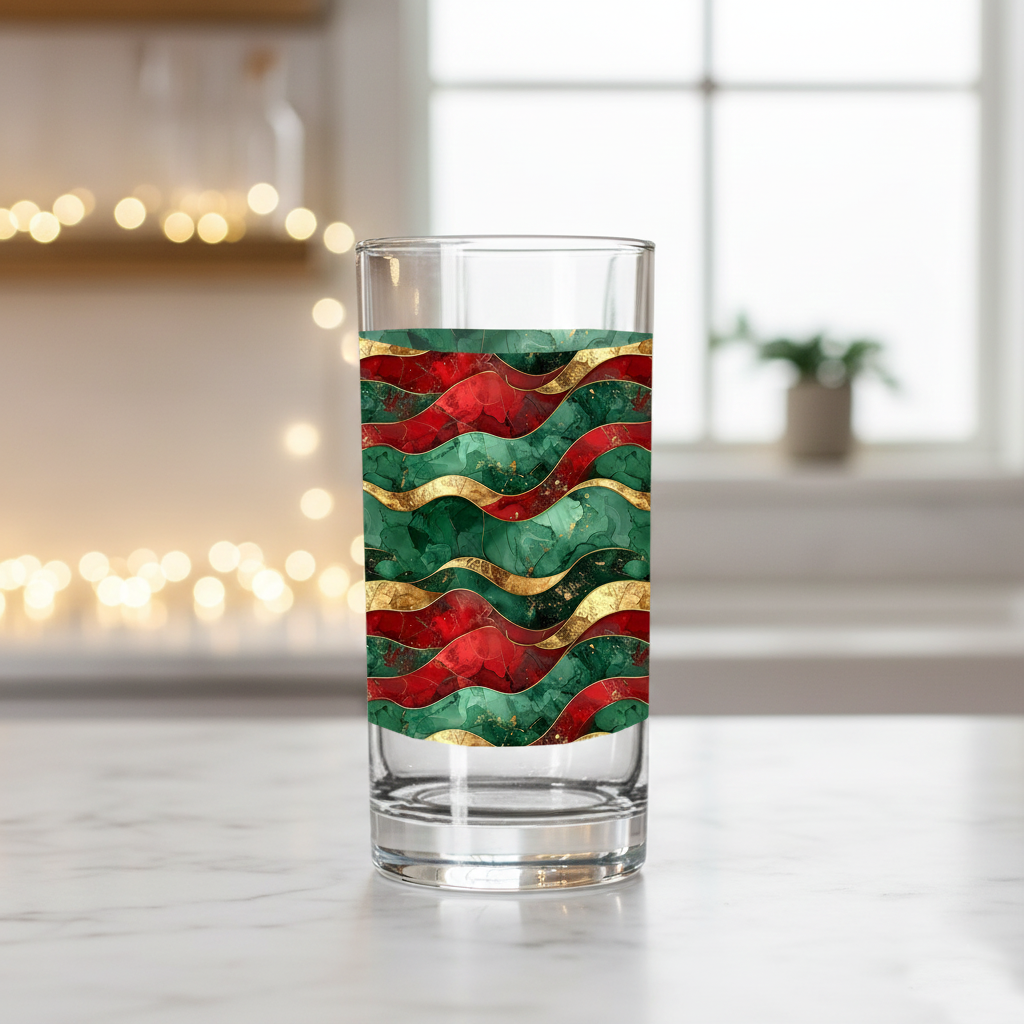 Royal Flux highball glass with jewel-toned waves design in red, green, and gold closeup on countertop with  a blurred kitchen background.