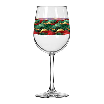 Wine glass with decorative band featuring red, green, and gold wavy design on a white background