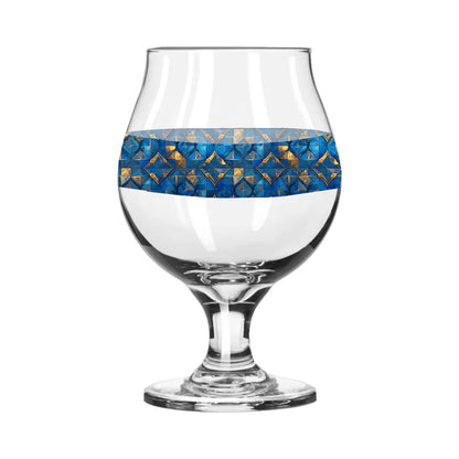 Belgian beer glass with turqoise and gold geometric design on a white background
