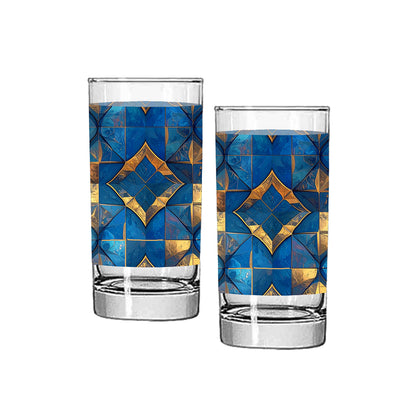 Two highball glasses with turqoise and gold geometric design on a white background