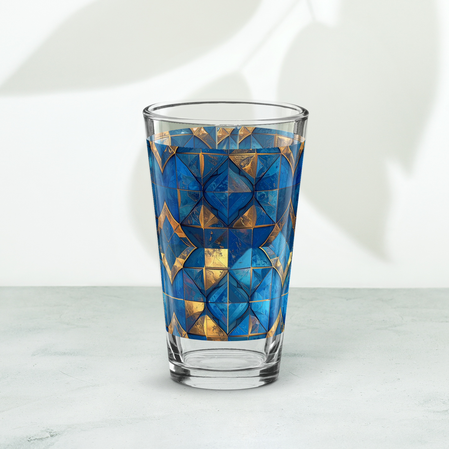 Moroccan Treasure pint beer glass closeup with turquoise and gold design on a white background