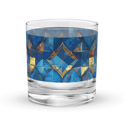 Glass rocks glass with turqoise and gold geometric design on a white background
