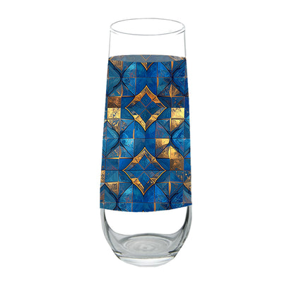 Stemless chmpagne glass with turqoise and gold geometric design on a white background