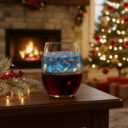 Moroccan Treasure stemless wine glass of red wine with decorative blue and gold pattern on a table in front of a fireplace and Christmas tree.