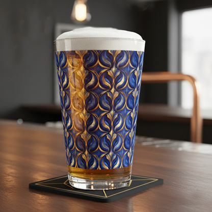 Sapphire Oracle pint glass of beer with a blue and gold pattern on a coaster, blurred background