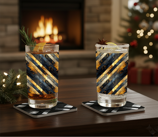 Two Obsidian Stripes black and gold diagonal striped glasses on a table in front of a fireplace and Christmas tree.