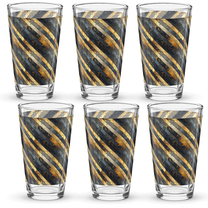 Set of six pint beer glasses with gold and black striped pattern on a white background