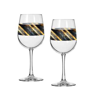 Two wine glasses with decorative black and gold stripes on a white background