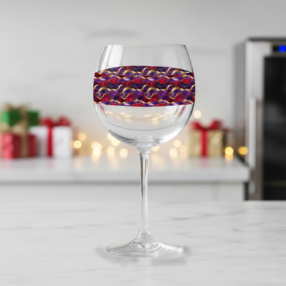 Fluid Marble balloon wine glass with purple and gold design on a marble kitchen island with wrapped presents in the background.