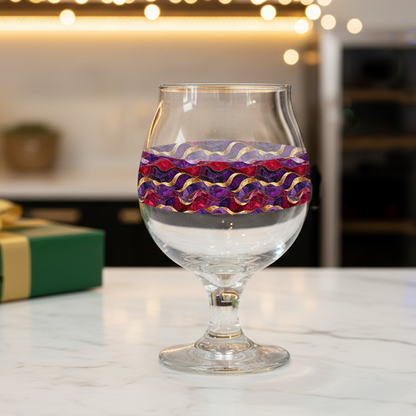 Fluid Marble signature Belgian beer glass with purple and gold pattern displayed on a marble countertop.