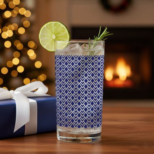 c with cocktail drink and garnish, and an Art-,Deco design on a wooden table with a blurred festive background.