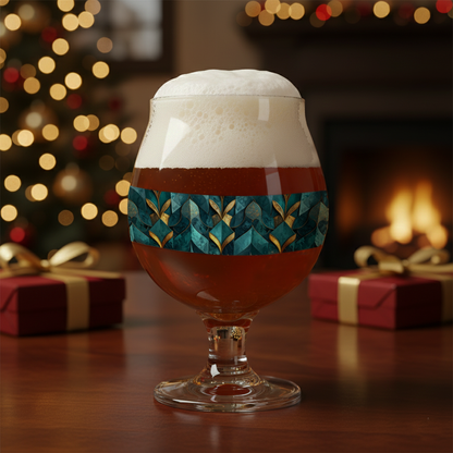 Gilded Patina Belgian glass of dark beer with teal and gold pattern on a wooden table, blurred bar background