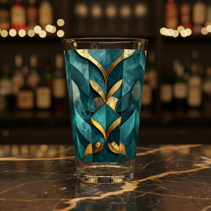 Gilded Patina glass with teal and gold architectural pattern on a dark marble surface with blurred bar background.
